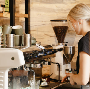 barista makiing coffee at coffee machine