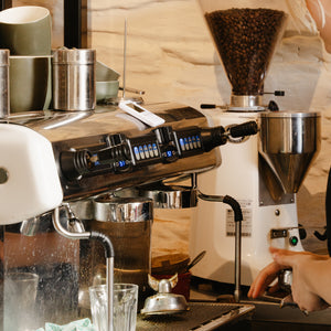 barista making coffee at espresso machine