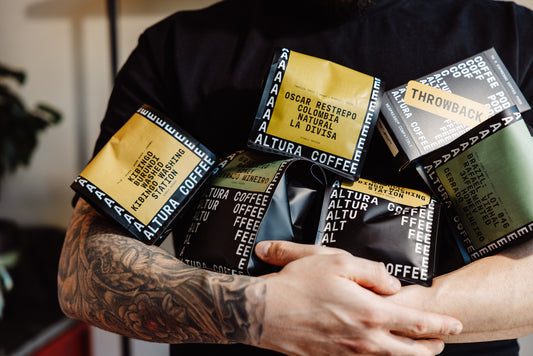 Arms full of Altura Coffee single origin coffee bags