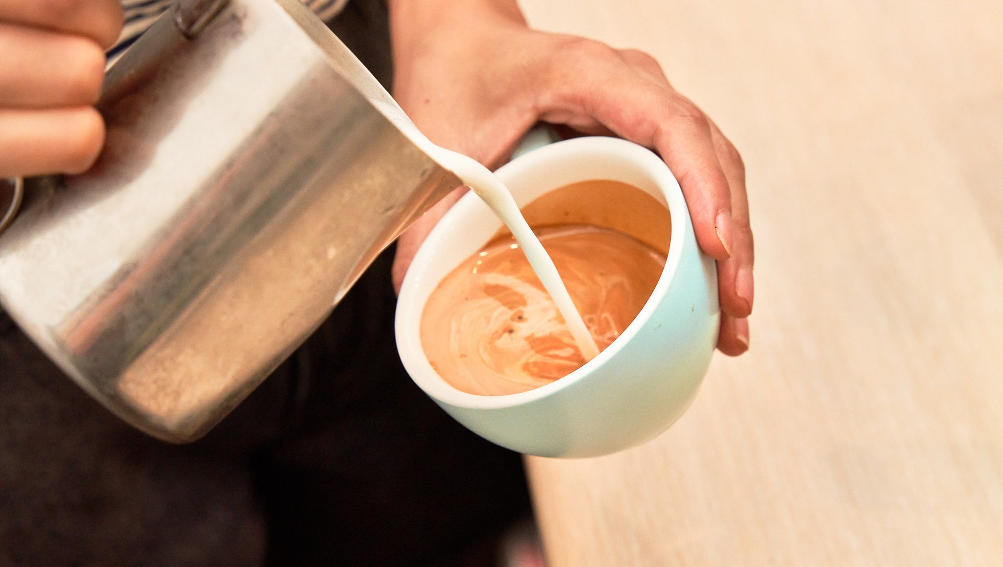 Altura Coffee Barista pouring Latte Art