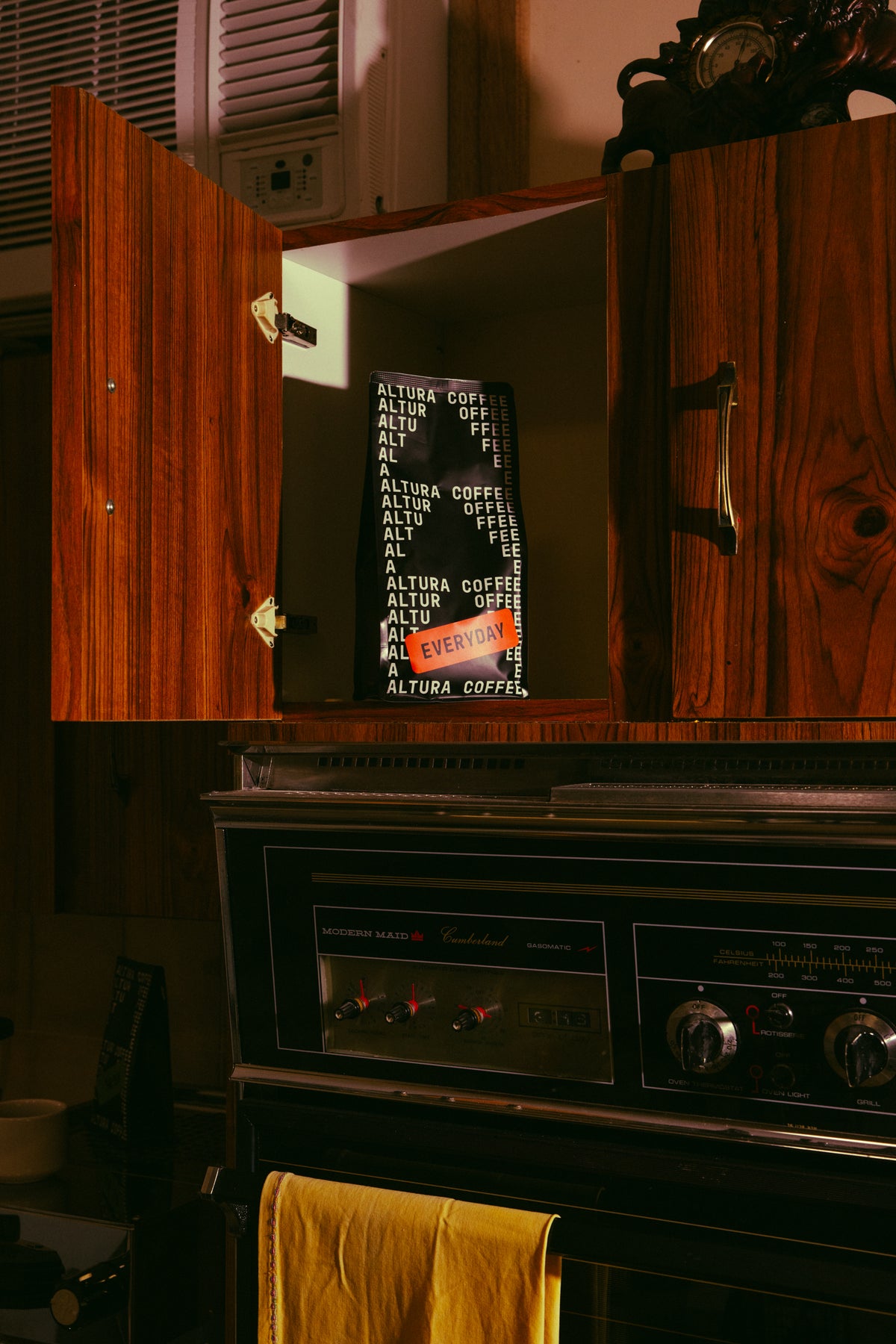 Altura Coffee Everyday espresso blend bag in a kitchen cupboard above the oven